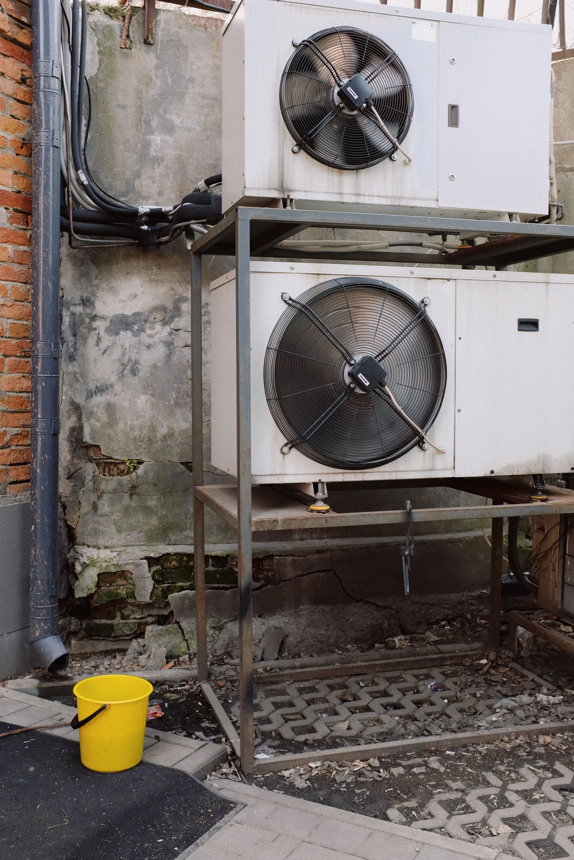 Commercial AC condenser units on metal frame at a Dallas retail property