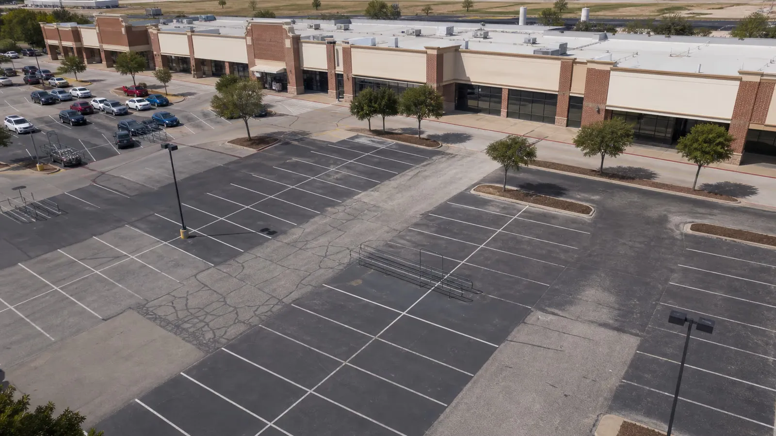 Aerial view of a strip retail center parking lot in Dallas-Fort Worth